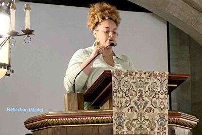Young woman speaking from a podium in a chapel